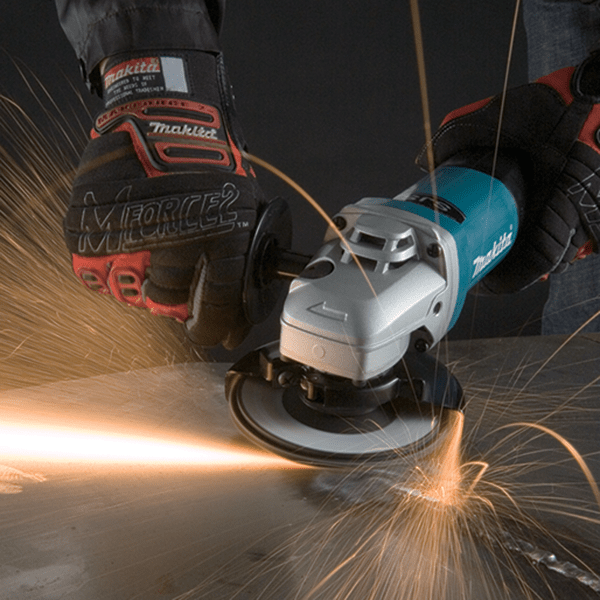Cordless angle grinder cutting metal with sparks